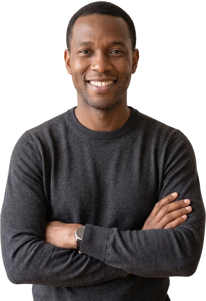 Daniel Okafor, smiling, arms crossed, in a charcoal sweater